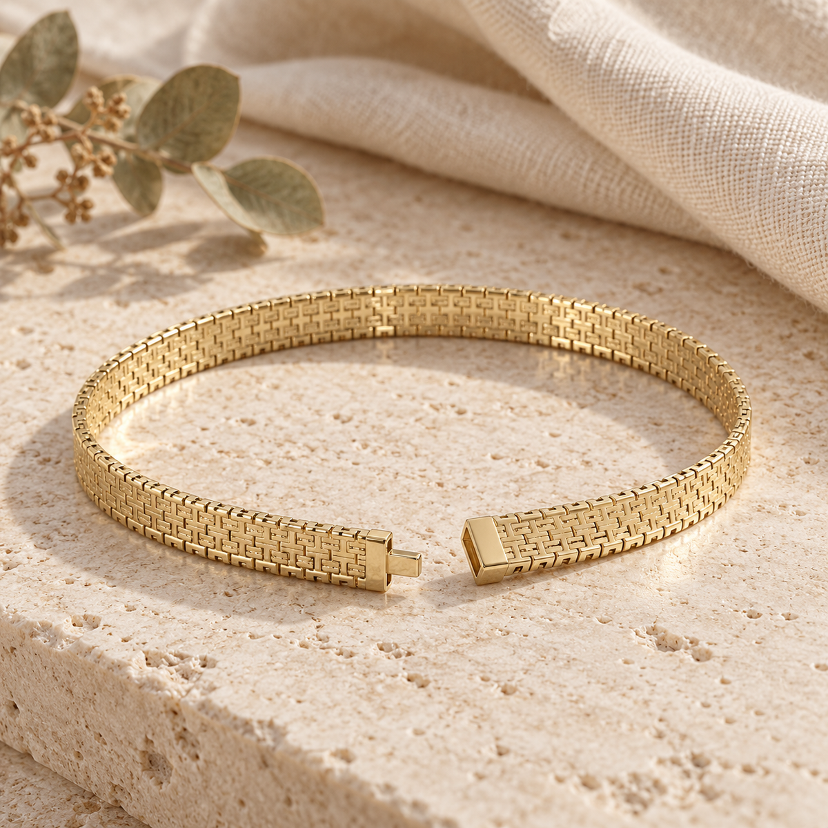 Gold-plated woven link bracelet on travertine