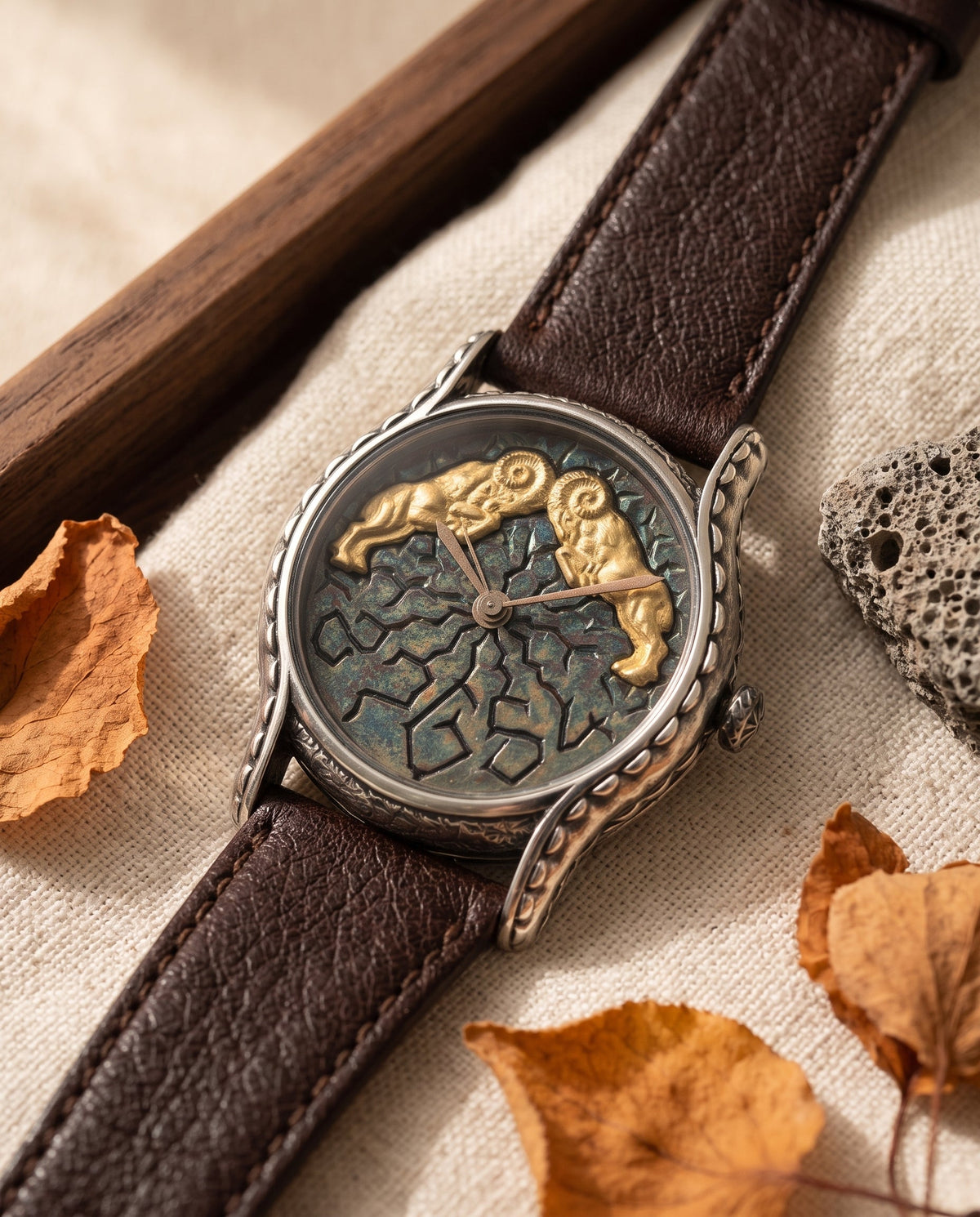 Aurelliani watch with two golden rams on a cracked enamel dial, brown leather strap