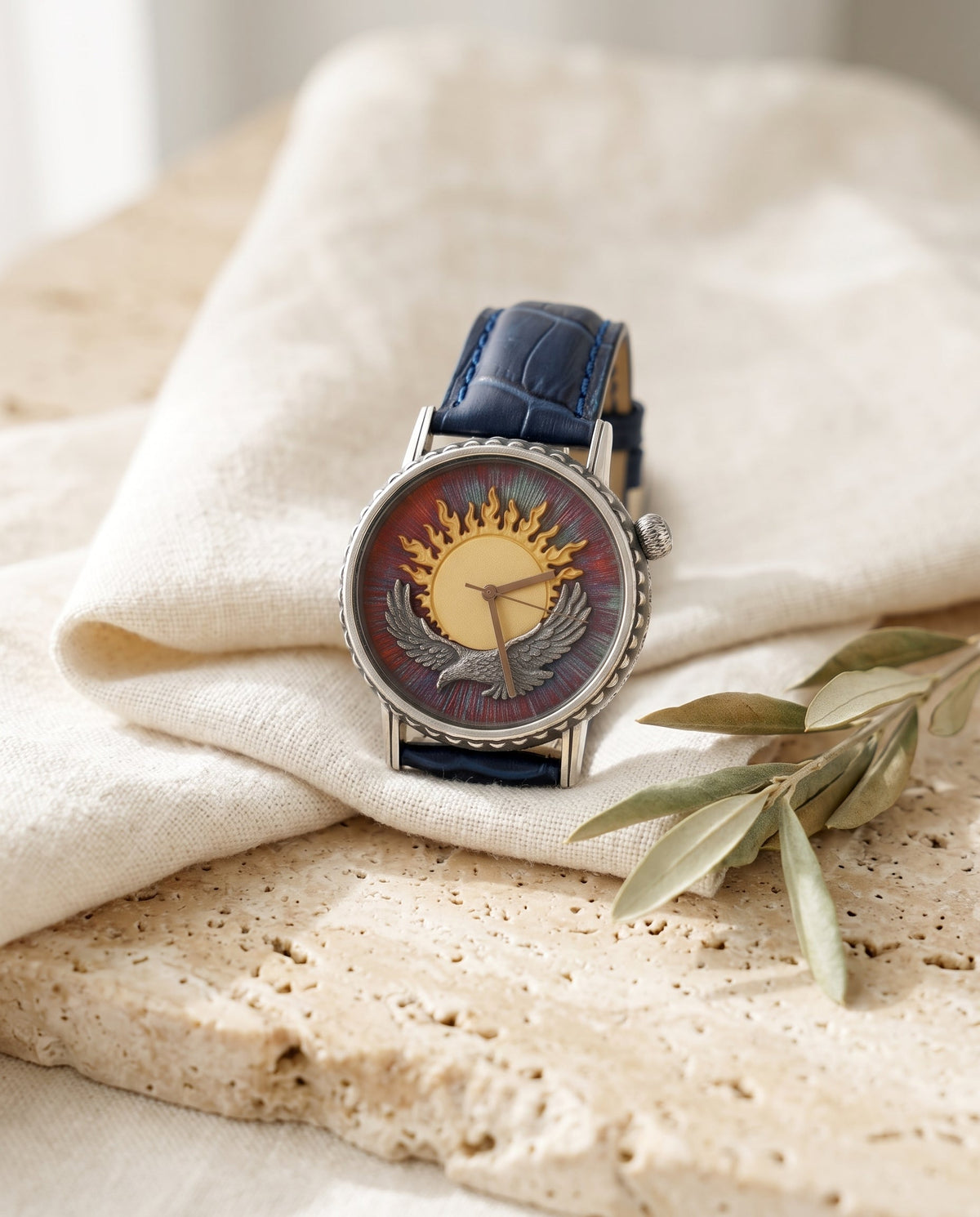 Aurelliani sun and eagle watch, red enamel dial, navy crocodile strap, on cream linen