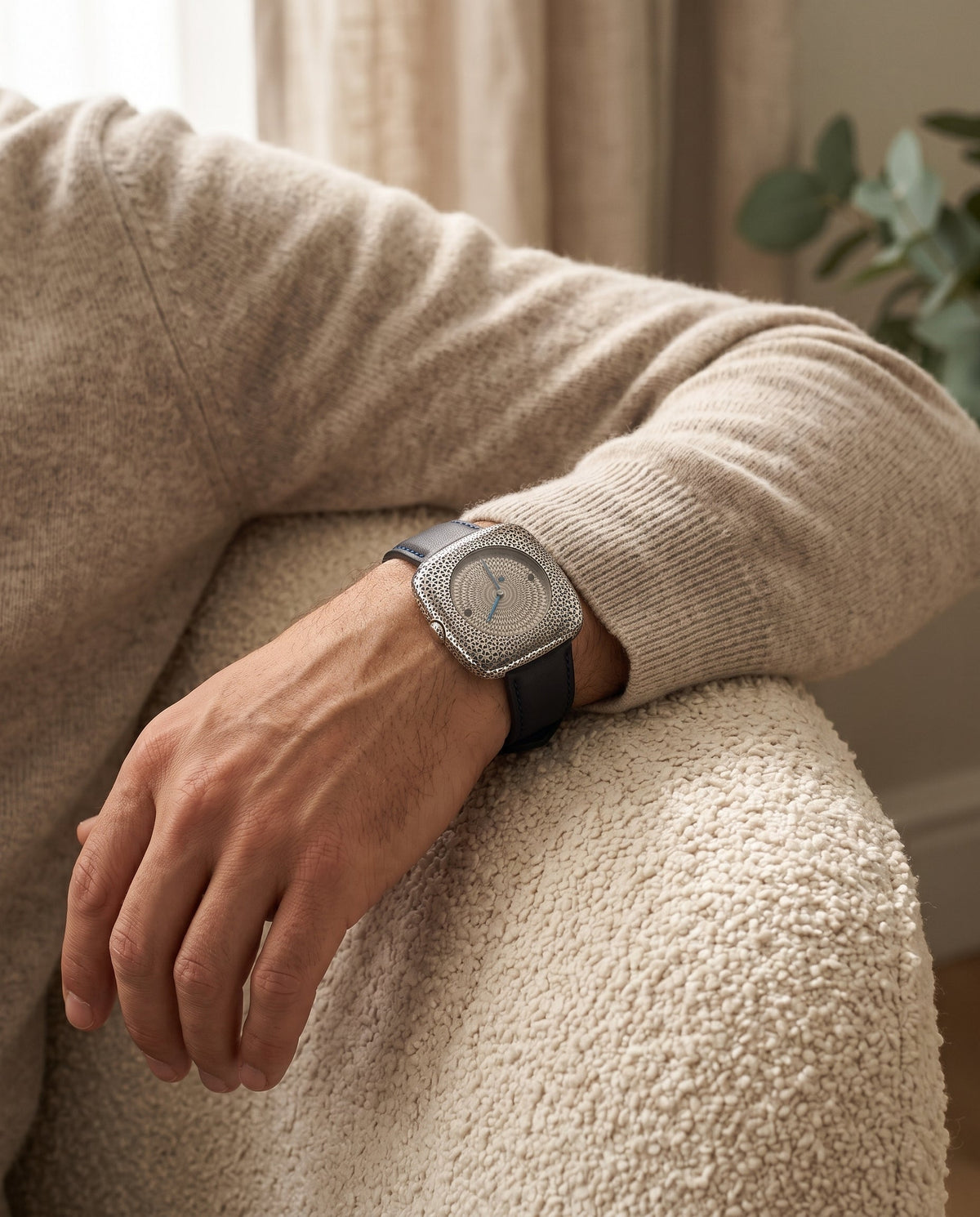 Aurelliani square honeycomb-engraved silver watch worn on a man's wrist
