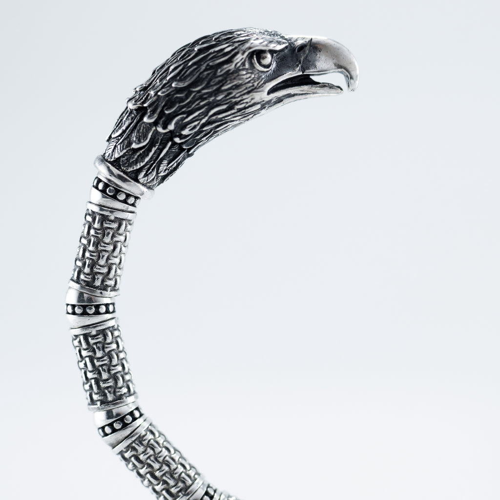 Silver eagle cuff from the side, woven segments along the band