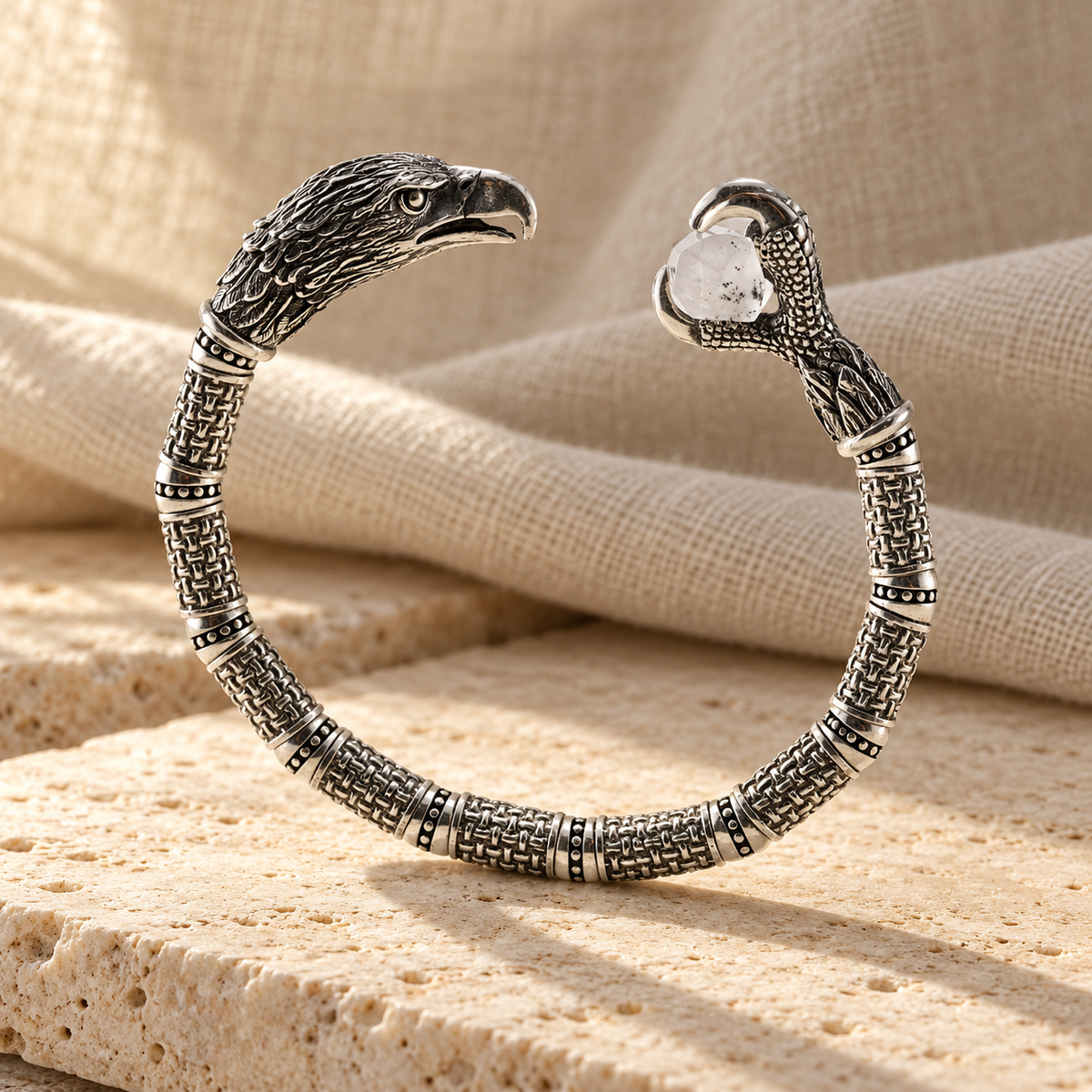 Silver eagle cuff on travertine and linen