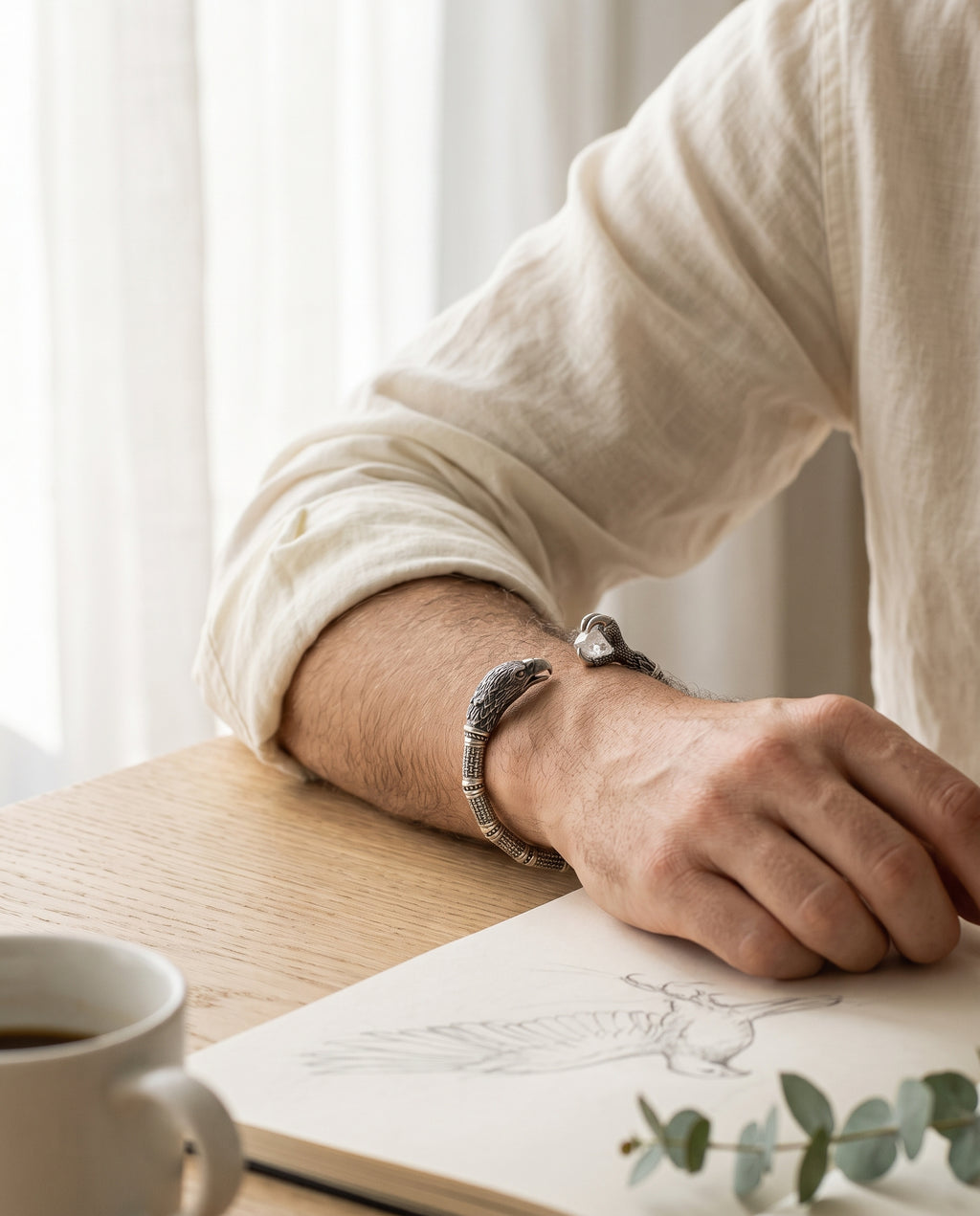 Silver eagle cuff worn on the wrist