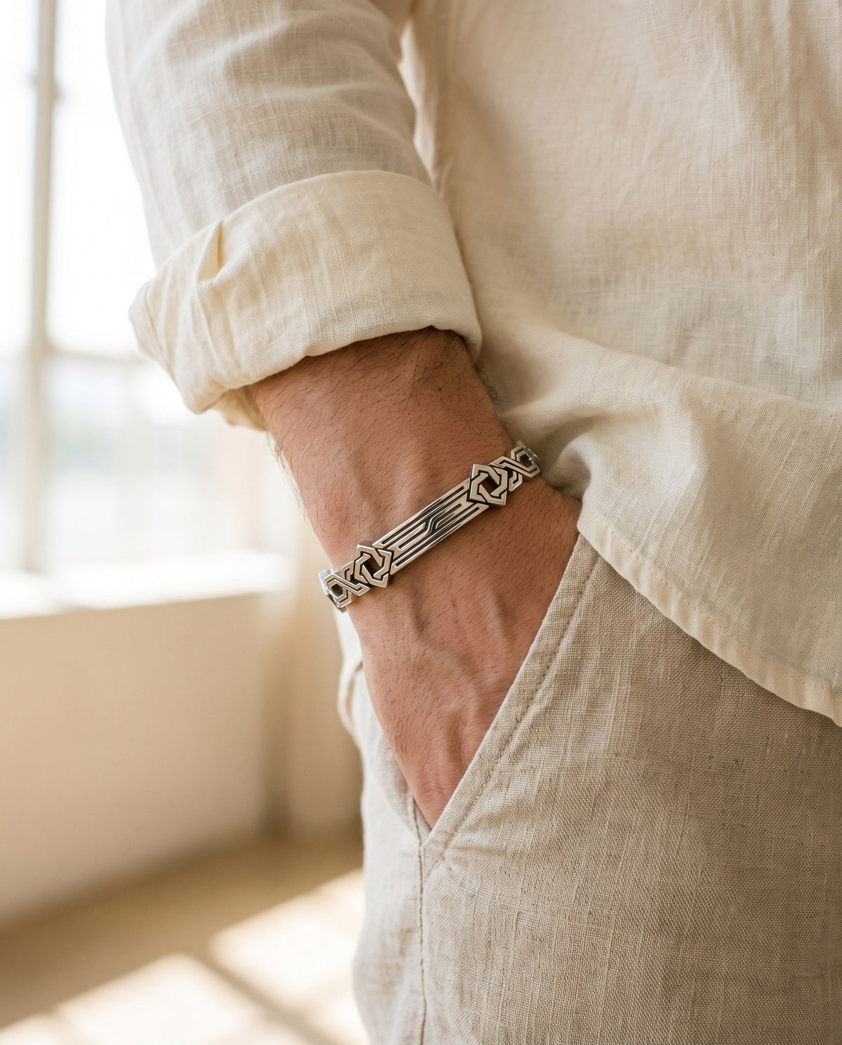 The bracelet worn with a linen shirt, hand in pocket