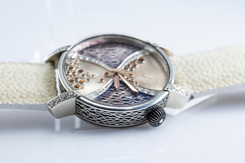 Close view of the silver watch case and stingray leather strap
