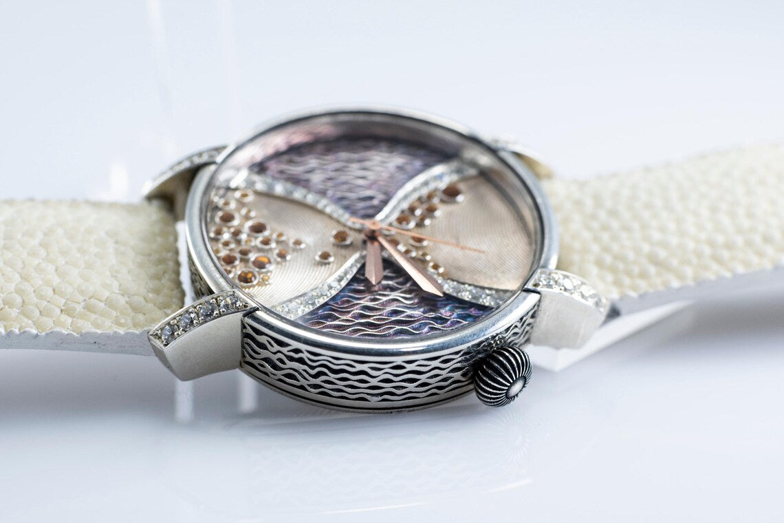 Close view of the silver watch case and stingray leather strap