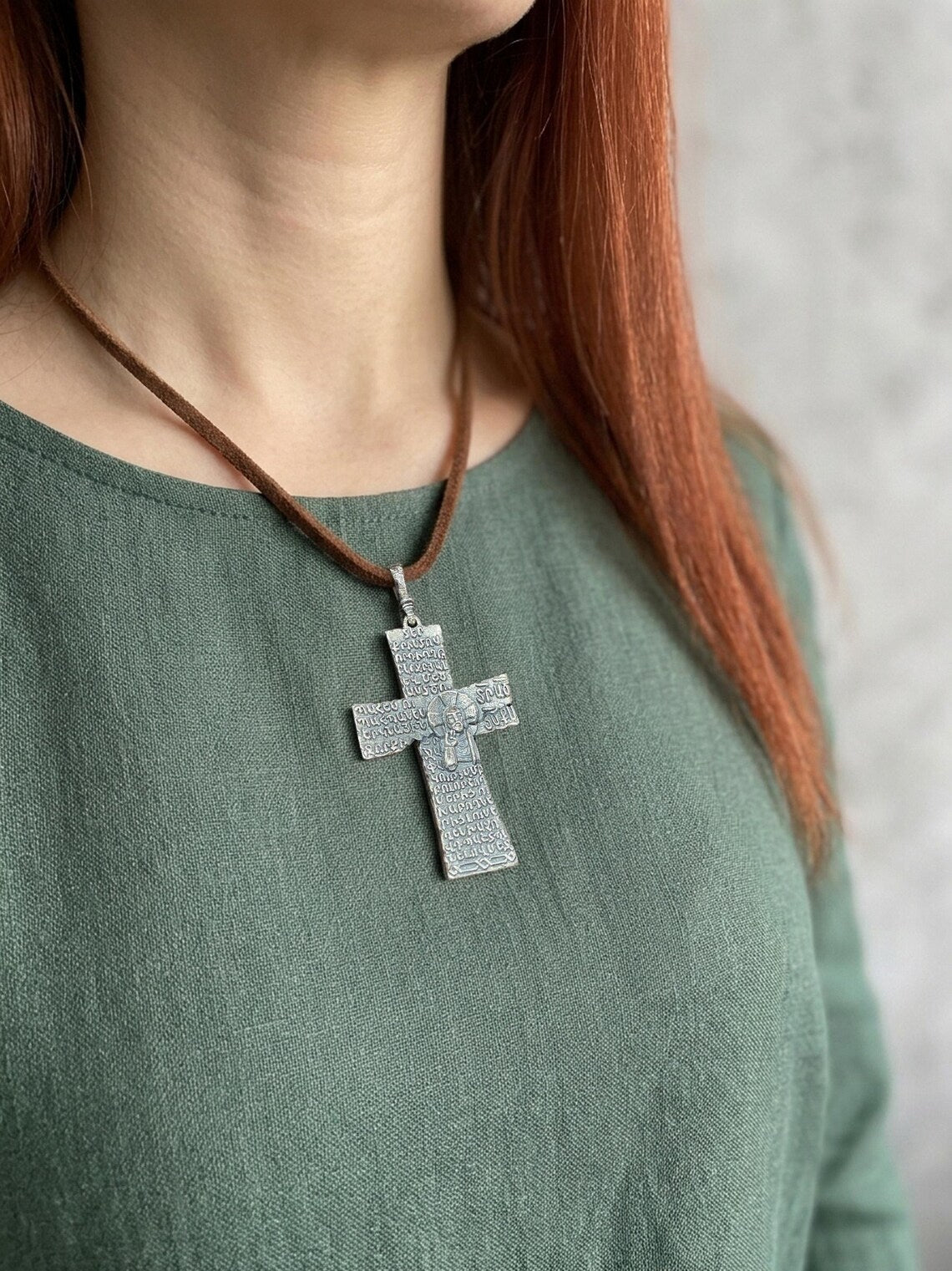 Armenian cross pendant in sterling silver worn over a sage linen dress