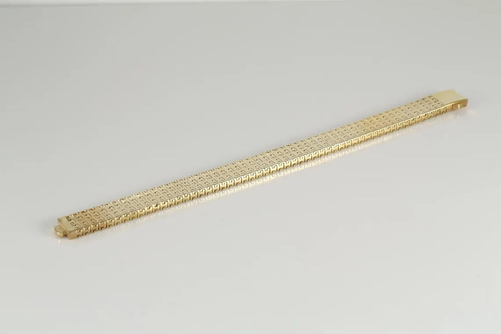 Gold-plated woven link bracelet laid straight