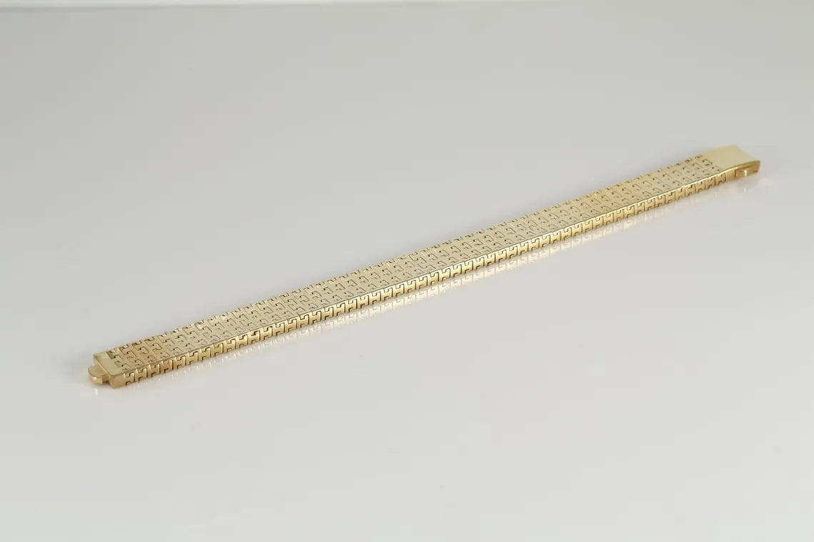 Gold-plated woven link bracelet laid straight