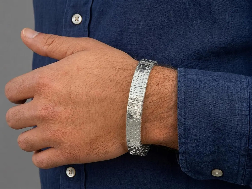 Silver woven bracelet on the wrist, side view